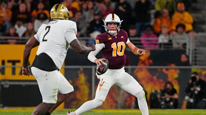 ASU quarterback Sam Leavitt (10) looks for receivers against UCF defensive lineman Kobe Hudson (2) during a game at Mountain America Stadium in Tempe on Nov. 9, 2024. ASU quarterback Sam Leavitt (10) looks for receivers against UCF defensive lineman Kobe Hudson (2) during a game at Mountain America Stadium in Tempe on Nov. 9, 2024.