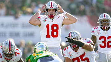 Ohio State Buckeyes quarterback Will Howard motions at the line of scrimmage during the College Football Playoff quarterfinal against the Oregon Ducks.