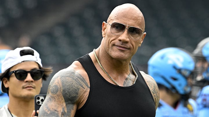 Mar 30, 2024; Arlington, TX, USA; UFL owner Dwayne Johnson aka The Rock walks off the field before the game between the Arlington Renegades and the Birmingham Stallions at Choctaw Stadium. Mandatory Credit: Jerome Miron-Imagn Images