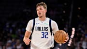 Oct 6, 2025; Fort Worth, Texas, USA; Dallas Mavericks forward Cooper Flagg (32) brings the ball up court during the game between the Dallas Mavericks and the Oklahoma City Thunder at Dickie's Arena. Mandatory Credit: Jerome Miron-Imagn Images