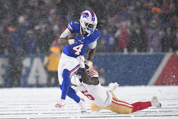 Dec 1, 2024; Orchard Park, New York, USA; Buffalo Bills running back James Cook (4) breaks a tackle by San Francisco 49ers sa