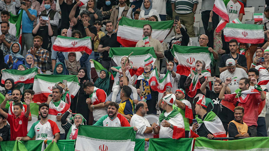 Supporters of Iran celebrate a soccer win and wave the Iranian flag.