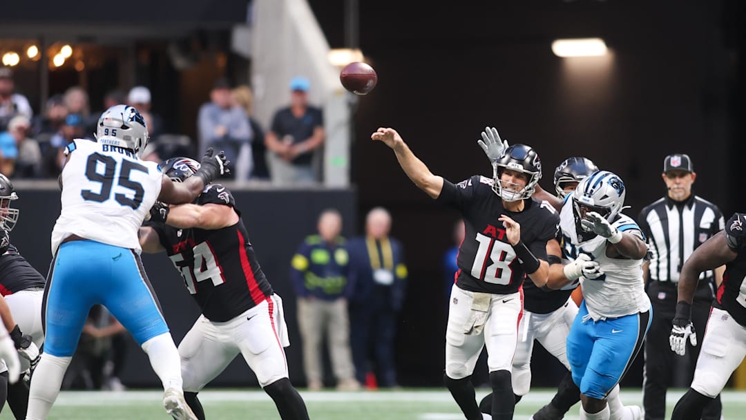 Nov 16, 2025; Atlanta, Georgia, USA; Atlanta Falcons quarterback Kirk Cousins (18) is pressured to throw in the fourth quarter against the Carolina Panthers at Mercedes-Benz Stadium. Mandatory Credit: Brett Davis-Imagn Images