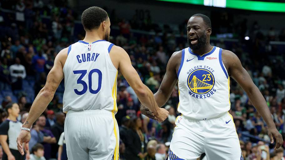 Warriors forward Draymond Green celebrates with guard Stephen Curry.