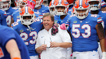 Oct 28, 2017; Jacksonville, FL, USA;Florida Gators head coach Jim McElwain gets pumped up with defensive back Chauncey Gardner Jr. (23) and offensive lineman Kavaris Harkless (53) before the game against the Georgia Bulldogs at EverBank Field. Mandatory Credit: Kim Klement-Imagn Images