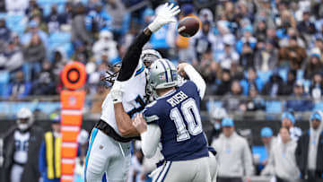Dec 15, 2024; Charlotte, North Carolina, USA; Carolina Panthers linebacker Jadeveon Clowney (7) leaps to block a pass by Dallas Cowboys quarterback Cooper Rush (10) during the second quarter at Bank of America Stadium. Mandatory Credit: Jim Dedmon-Imagn Images