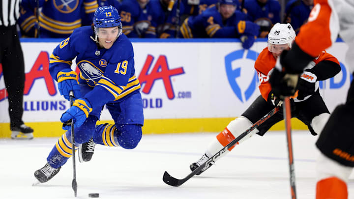 Apr 5, 2024; Buffalo, New York, USA;  Buffalo Sabres center Peyton Krebs (19) controls the puck as Philadelphia Flyers right wing Cam Atkinson (89) defends during the second period at KeyBank Center. Mandatory Credit: Timothy T. Ludwig-Imagn Images