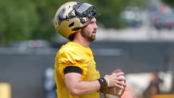 Purdue Boilermakers quarterback Hudson Card (1) holds onto a football Wednesday, July 31, 2024, during Purdue football practice at Bimel Outdoor Practice Complex in West Lafayette, Ind.