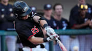 Georgia catcher Daniel Jackson (25) hits the ball during a NCAA baseball game against Arkansas in Athens, Ga., on Friday, April 11, 2025.