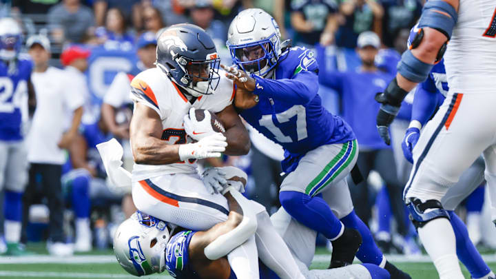 Sep 8, 2024; Seattle, Washington, USA; Seattle Seahawks defensive end Leonard Williams (99) and linebacker Jerome Baker (17) tackle Denver Broncos running back Audric Estime (23) for a loss during the third quarter at Lumen Field.