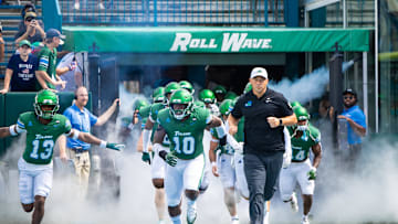 Aug 30, 2025; New Orleans, Louisiana, USA; Tulane Green Wave head coach Jon Sumrall runs out the tunnel with defensive end Gerrod Henderson (10) and safety Tavare Smith (13) against Northwestern Wildcats during the first half at Yulman Stadium. Mandatory Credit: Stephen Lew-Imagn Images