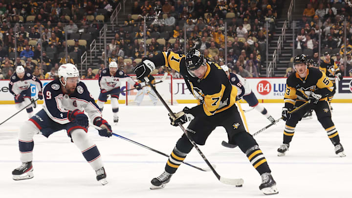 Mar 21, 2025; Pittsburgh, Pennsylvania, USA;  Pittsburgh Penguins center Evgeni Malkin (71) moves the puck against Columbus Blue Jackets defenseman Ivan Provorov (9) during the third period at PPG Paints Arena. Mandatory Credit: Charles LeClaire-Imagn Images