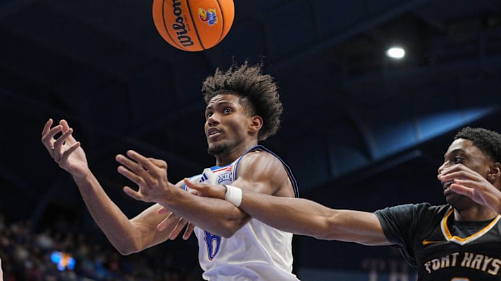 Oct 28, 2025; Lawrence, KS, USA; Kansas Jayhawks forward Samis Calderon (6) and Fort Hays State Tigers forward Dan Mukuna (0) fight for a rebound during the first half at Allen Fieldhouse. Mandatory Credit: Jay Biggerstaff-Imagn Images