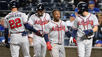 Former Atlanta Braves center fielder Billy Hamilton (9) and second baseman Ozzie Albies (1), and shortstop Dansby Swanson (7) celebrate with right fielder Nick Markakis (22) after scoring in the eighth inning against the Kansas City Royals at Kauffman Stadium.