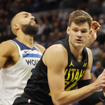 Nov 30, 2023; Minneapolis, Minnesota, USA; Utah Jazz center Walker Kessler (24) grabs a rebound ahead of Minnesota Timberwolves center Rudy Gobert (27) in the first quarter at Target Center. Mandatory Credit: Bruce Kluckhohn-USA TODAY Sports