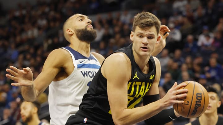 Nov 30, 2023; Minneapolis, Minnesota, USA; Utah Jazz center Walker Kessler (24) grabs a rebound ahead of Minnesota Timberwolves center Rudy Gobert (27) in the first quarter at Target Center. Mandatory Credit: Bruce Kluckhohn-USA TODAY Sports