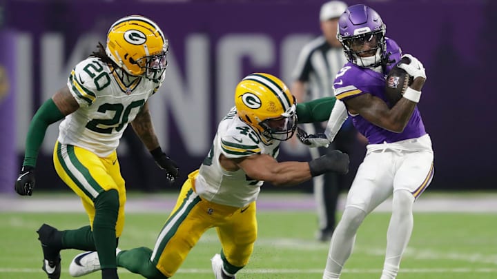 Minnesota Vikings wide receiver Jordan Addison (3) gets a first down reception against Green Bay Packers safety Javon Bullard (20) and linebacker Eric Wilson (45) in the second quarter during their football game Sunday, December 29, 2024, at U.S. Bank Stadium in Minneapolis, Minnesota.