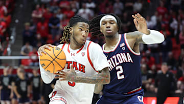 Feb 8, 2024; Salt Lake City, Utah, USA; Utah Utes guard Deivon Smith (5) goes to the basket against Arizona Wildcats guard Caleb Love (2) during the second half at Jon M. Huntsman Center. Mandatory Credit: Rob Gray-Imagn Images