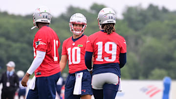Jul 24, 2024; Foxborough, MA, USA;  New England Patriots quarterback Drake Maye (10) waits for drills to start with quarterback Jacoby Brissett (14) and quarterback Joe Milton III (19) training camp at Gillette Stadium. Mandatory Credit: Eric Canha-Imagn Images