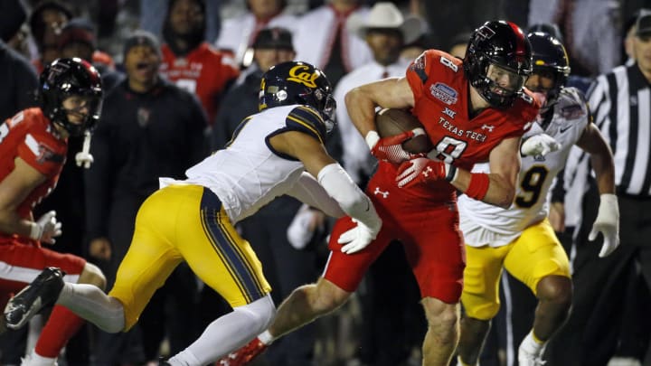 Dec 16, 2023; Shreveport, LA, USA; Texas Tech Red Raiders wide receiver Coy Eakin (8) runs after a catch as California Golden Bears defensive back Kaylin Moore (4) attempts to make the tackle during the first half at Independence Stadium. Mandatory Credit: Petre Thomas-USA TODAY Sports