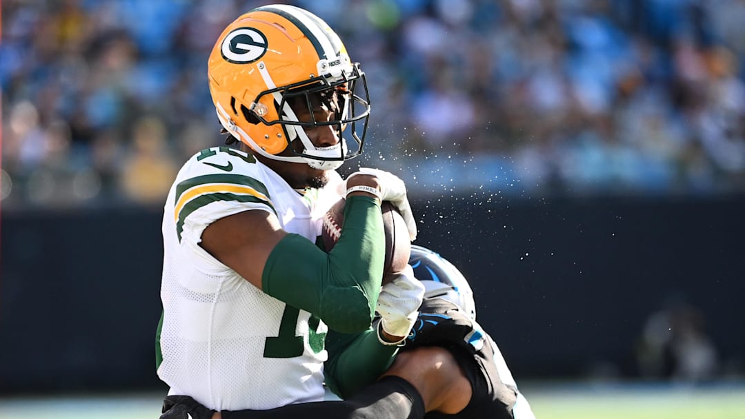 Green Bay Packers wide receiver Malik Heath (18) is tackled by Carolina Panthers safety Vonn Bell (24) in the second quarter at Bank of America Stadium.
