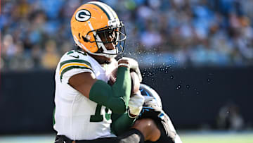 Green Bay Packers wide receiver Malik Heath (18) is tackled by Carolina Panthers safety Vonn Bell (24) in the second quarter at Bank of America Stadium.