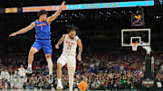 Houston guard Emanuel Sharp looks helpless after losing the ball as he attempts to shoot against Florida guard Walter Clayton Jr. in the final seconds of the national title game.