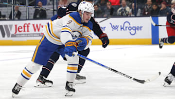 Oct 17, 2024; Columbus, Ohio, USA; Buffalo Sabres left wing  Zach Benson (9) reaches after a loose puck as Columbus Blue Jackets defenseman Jack Johnson (3) defends during the first period at Nationwide Arena. Mandatory Credit: Russell LaBounty-Imagn Images