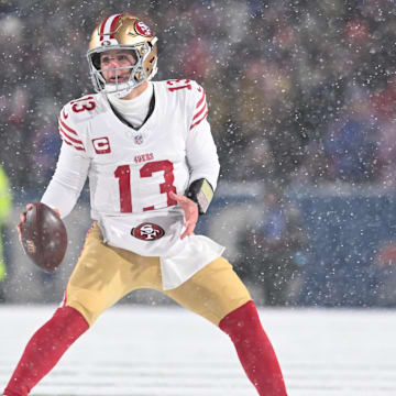 Dec 1, 2024; Orchard Park, New York, USA; San Francisco 49ers quarterback Brock Purdy (13) moves out of the pocket to throw a pass against the Buffalo Bills in the second quarter at Highmark Stadium. Mandatory Credit: Mark Konezny-Imagn Images