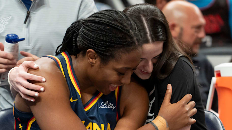 Indiana Fever forward Boston and Clark embrace on the bench at Gainbridge Fieldhouse | HG Biggs/IndyStar / USA TODAY NETWORK via Imagn Images