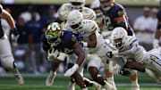 Oct 19, 2024; Atlanta, Georgia, USA; Notre Dame Fighting Irish running back Jadarian Price (24) is tackled by Georgia Tech Yellow Jackets defensive back Taye Seymore (7) in the third quarter at Mercedes-Benz Stadium. Mandatory Credit: Brett Davis-Imagn Images