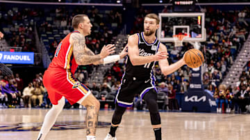 Dec 12, 2024; New Orleans, Louisiana, USA; Sacramento Kings forward Domantas Sabonis (11) dribbles against New Orleans Pelicans center Daniel Theis (10) during the second half at Smoothie King Center. Mandatory Credit: Stephen Lew-Imagn Images