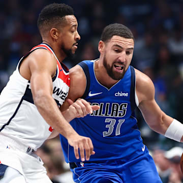 Oct 24, 2025; Dallas, Texas, USA;  Dallas Mavericks guard Klay Thompson (31) drives to the basket as Washington Wizards guard CJ McCollum (3) defends during the first quarter at American Airlines Center. Mandatory Credit: Kevin Jairaj-Imagn Images