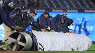 Apr 11, 2025; Bronx, New York, USA; New York Yankees grounds crew rolls out the tarp during the top of the sixth inning against the San Francisco Giants at Yankee Stadium. 