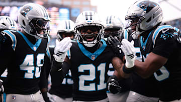 Nov 30, 2025; Charlotte, North Carolina, USA; Carolina Panthers safety Nick Scott (21) celebrates a defensive touchdown scored by Carolina Panthers cornerback Mike Jackson (2) (not pictured) during the first quarter against the Los Angeles Rams at Bank of America Stadium. 