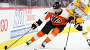 Mar 31, 2025; Philadelphia, Pennsylvania, USA; Philadelphia Flyers defenseman Cam York (8) and Nashville Predators left wing Michael Bunting (58) battle for the puck in the first period at Wells Fargo Center. Mandatory Credit: Kyle Ross-Imagn Images