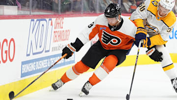 Mar 31, 2025; Philadelphia, Pennsylvania, USA; Philadelphia Flyers defenseman Cam York (8) and Nashville Predators left wing Michael Bunting (58) battle for the puck in the first period at Wells Fargo Center. Mandatory Credit: Kyle Ross-Imagn Images