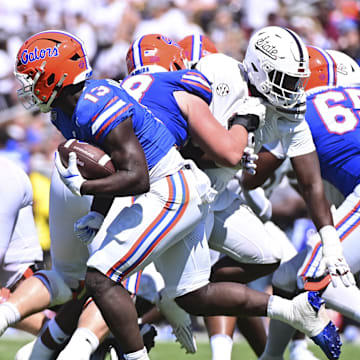Sep 21, 2024; Starkville, Mississippi, USA; Florida Gators running back Jadan Baugh (13) runs the ball against the Mississippi State Bulldogs during the fourth quarter at Davis Wade Stadium at Scott Field. Mandatory Credit: Matt Bush-Imagn Images