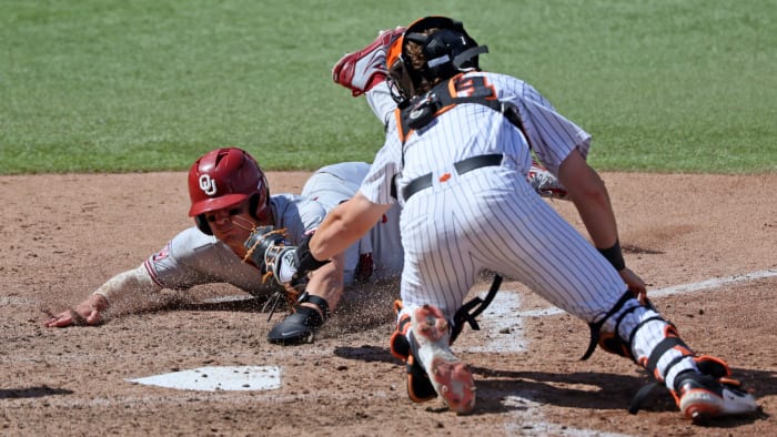 Oklahoma's Anthony MacKenzie (3) slides home.