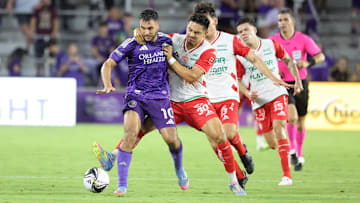Aug 6, 2025; Orlando, FL, USA; Club Necaxa forward Ricardo Monreal (30) gets a yellow card on Orlando City midfielder Martin Ojeda (10) during the second half at Inter&Co Stadium. Mandatory Credit: Kim Klement Neitzel-Imagn Images