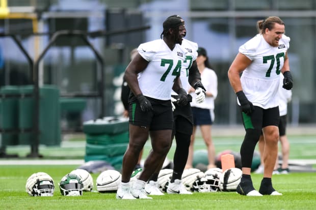 New York Jets offensive tackle Olu Fashanu warms up during training camp.