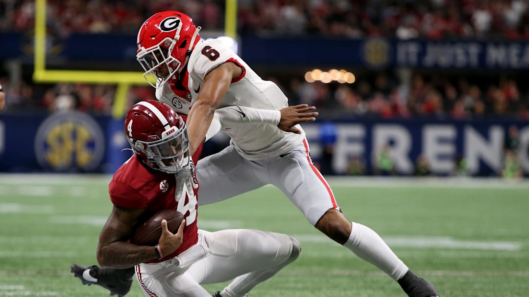 Dec 2, 2023; Atlanta, GA, USA; Georgia Bulldogs defensive back Daylen Everette (6) tackles Alabama Crimson Tide quarterback Jalen Milroe (4) in the third quarter at Mercedes-Benz Stadium. Mandatory Credit: Brett Davis-Imagn Images