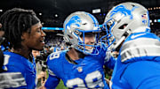Detroit Lions place kicker Jake Bates (39), center, is congratulated by teammates after scoring a game winning field goal against Green Bay Packer at Ford Field in Detroit on Thursday, Dec. 5, 2024.