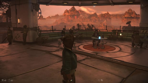 Star Wars Outlaws screenshot showing Kay in front of a bar's outdoor seating area in Mirogana.