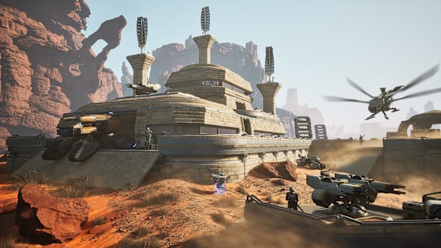 Dune: Awakening screenshot of a base with an ornithopter flying towards it.