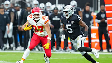 Oct 27, 2024; Paradise, Nevada, USA; Kansas City Chiefs tight end Travis Kelce (87) looks to evade the tackle of Las Vegas Raiders linebacker Divine Deablo (5) during the first quarter at Allegiant Stadium. Mandatory Credit: Stephen R. Sylvanie-Imagn Images