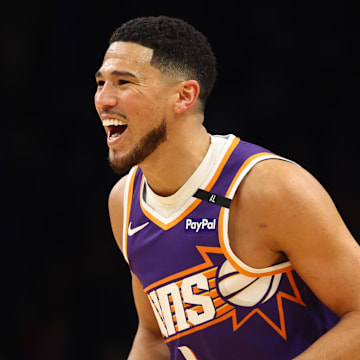 Mar 24, 2025; Phoenix, Arizona, USA; Phoenix Suns guard Devin Booker (1) reacts against the Milwaukee Bucks at Footprint Center. Mandatory Credit: Mark J. Rebilas-Imagn Images