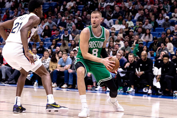 Boston Celtics Center Kristaps Porzingis (8) seeks to pass against New Orleans Pelicans Center Yves Missi (21) 