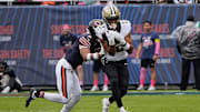 Oct 19, 2025; Chicago, Illinois, USA; New Orleans Saints wide receiver Chris Olave (12) runs with the ball after making a catch against Chicago Bears cornerback Kyler Gordon (6) during the first half at Soldier Field. Mandatory Credit: David Banks-Imagn Images