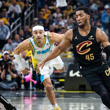 Donovan Mitchell, now engaged to Coco Jones, dribbles the ball during a playoff game against the Pacers.